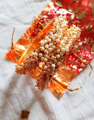 B0222_Lovely golden pearl bangles with delicate craftwork embellished with a bunch of pearls.