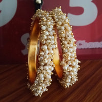 B0222_Lovely golden pearl bangles with delicate craftwork embellished with a bunch of pearls.