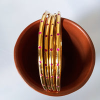 B0226_Beautiful sleek design  golden bangles with a touch of pink stones.