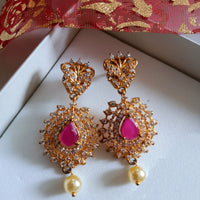 E0647_Gorgeous crafted design danglers studded with american diamond stones with a touch of pink ruby stones with a pearl drop.