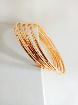 B0227_Beautiful sleek design  golden bangles with a touch of stones.