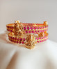 B0229_Traditional style lakshmi design golden bangles with a touch of  pink ruby stones.