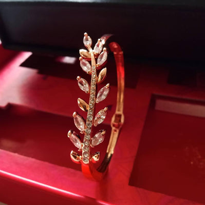 B0225_Elegant rose gold color bangle style bracelet studded with dazzling american diamond stones with delicate craft work.