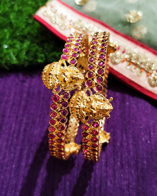 B0229_Traditional style lakshmi design golden bangles with a touch of  pink ruby stones.