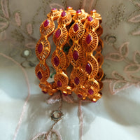 B0240_Traditional style Gold plated bangles studded with pink ruby stones.