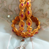 B0240_Traditional style Gold plated bangles studded with pink ruby stones.