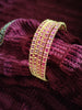 B0257_Gorgeous golden bangles embellished with a touch of pink ruby stones.