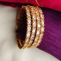 B0269_Classy sleek Gold plated bangles studded with  American Diamond  stones with delicate stone work.