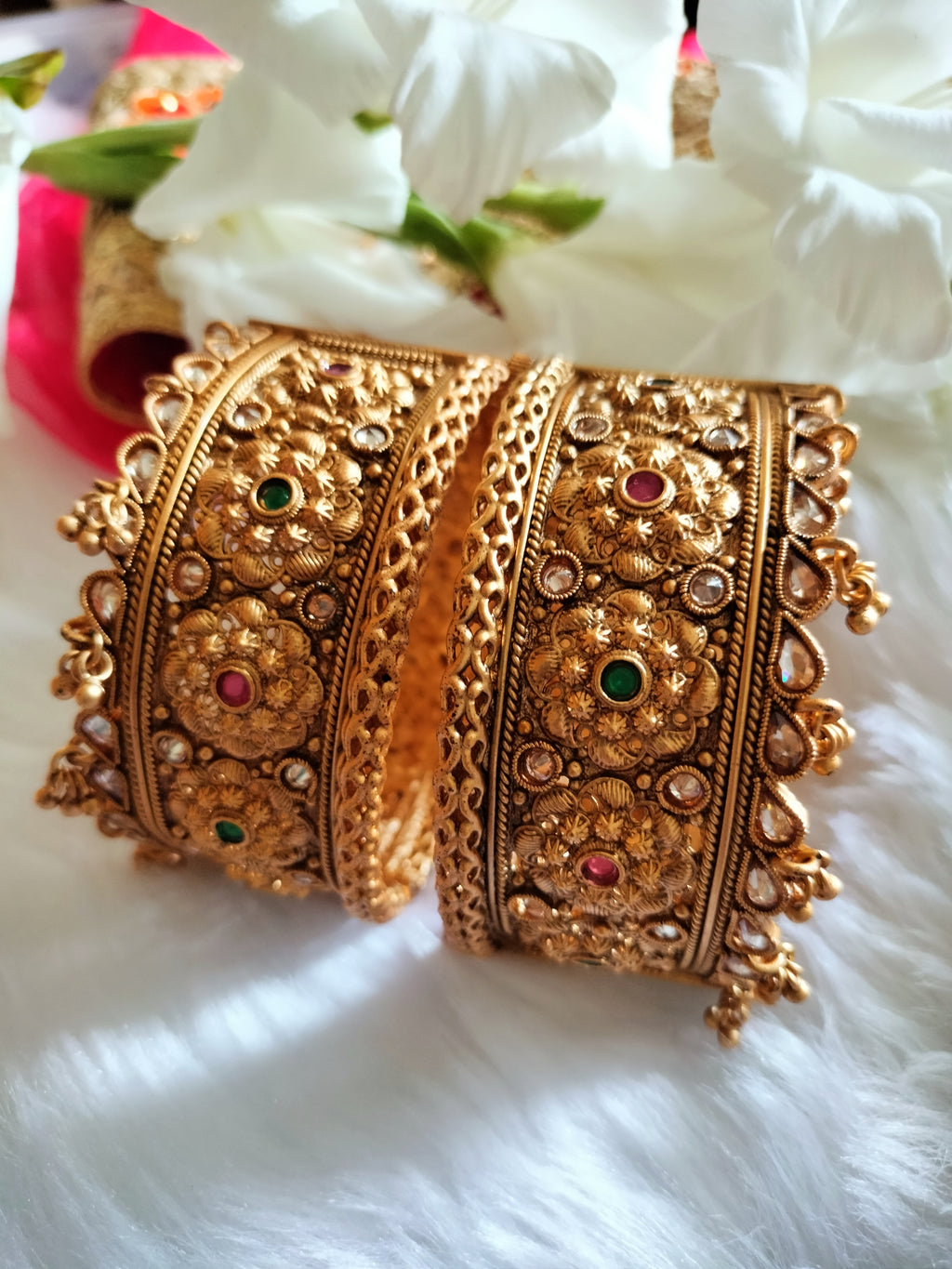 B0281_Grand broad style Ethnic screw design bangles with delicate work with a touch of ruby and american diamond stones along with bead drops.