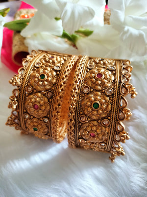 B0281_Grand broad style Ethnic screw design bangles with delicate work with a touch of ruby and american diamond stones along with bead drops.