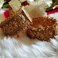 B0281_Grand broad style Ethnic screw design bangles with delicate work with a touch of ruby and american diamond stones along with bead drops.