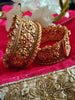 B0281_Grand broad style Ethnic screw design bangles with delicate work with a touch of ruby and american diamond stones along with bead drops.