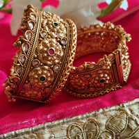 B0281_Grand broad style Ethnic screw design bangles with delicate work with a touch of ruby and american diamond stones along with bead drops.
