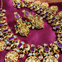 N0555_Traditional temple jewelry style Lakshmi design gold plated necklace set embellished with ruby stones .