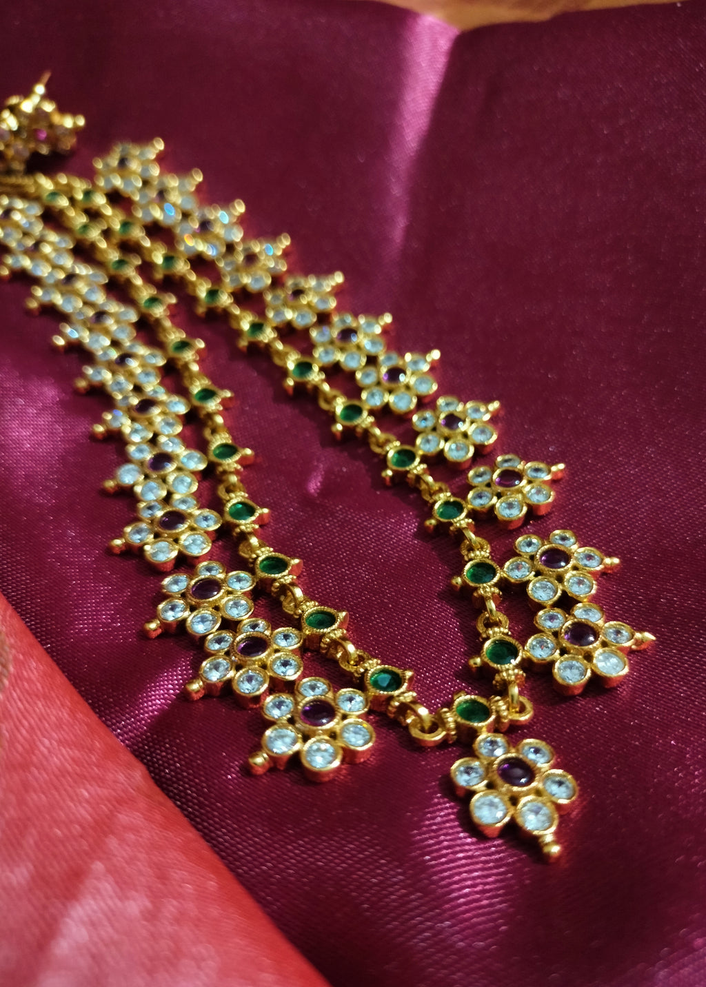 N0554_Elegant temple jewelry style flower design gold plated necklace set embellished with ruby stones .