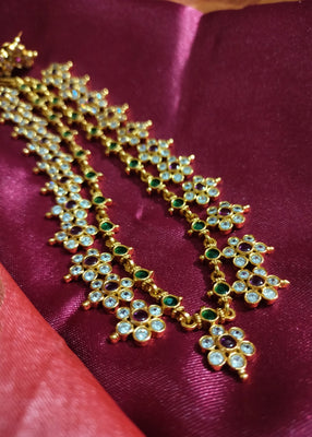 N0554_Elegant temple jewelry style flower design gold plated necklace set embellished with ruby stones .
