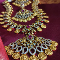 N0553_Grand temple jewelry style Lakshmi design gold plated necklace set embellished with ruby stones .