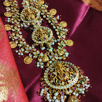 N0552_Grand designer lakshmi design gold plated necklace set embellished with ruby stones with a touch of bead drops.