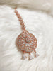 M026_Classic flower design oval shaped rose gold American diamond studded Maang tika with delicate stone work.