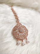 M026_Classic flower design oval shaped rose gold American diamond studded Maang tika with delicate stone work.