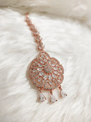 M026_Classic flower design oval shaped rose gold American diamond studded Maang tika with delicate stone work.