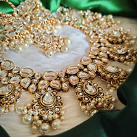 N0587_Royal Bridal style Elaborated choker necklace set studded with Kundan stones with a touch of glossy pearls.