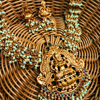 N0558_Classic temple jewelry style Lakshmi design gold plated necklace set embellished with ruby stones with a touch of pearls.