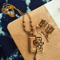 N0560_Classic temple jewelry style Mangal sutra design gold plated necklace set embellished with ruby stones .