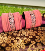B02005_Elegant flowery design Bangles studded with American Diamond stones with a touch of baby pink stones with delicate stone work. Also 2 Dozens of pink velvet bangles