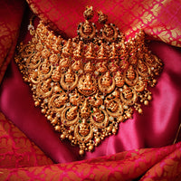 N03065_Grand Choker classic matte gold polished temple jewelry style crafted design gold plated necklace set embellished with ruby and green stones .