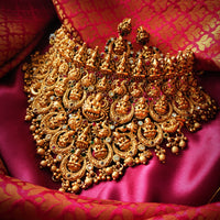 N03065_Grand Choker classic matte gold polished temple jewelry style crafted design gold plated necklace set embellished with ruby and green stones .