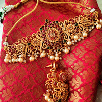 N03038_ classic matte gold polished temple jewelry choker style crafted design gold plated necklace set embellished with ruby and green stones .