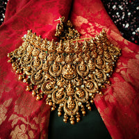 N03065_Grand Choker classic matte gold polished temple jewelry style crafted design gold plated necklace set embellished with ruby and green stones .