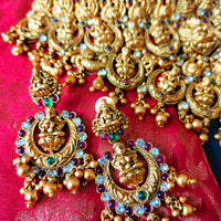 N03065_Grand Choker classic matte gold polished temple jewelry style crafted design gold plated necklace set embellished with ruby and green stones .