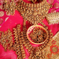 N03072_ Grand classic matte gold polished Complete Bridal temple jewelry choker style and Long Haram crafted design gold plated necklace set embellished with ruby and green stones .
