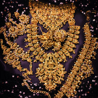 N03072_ Grand classic matte gold polished Complete Bridal temple jewelry choker style and Long Haram crafted design gold plated necklace set embellished with ruby and green stones .