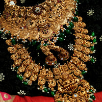 N03068_ Grand classic matte gold polished temple jewelry choker style and Long Haram crafted design gold plated necklace set embellished with ruby and green stones .