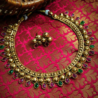 N03016_Classic matte gold polished temple jewelry style crafted design gold plated necklace set embellished with ruby and green stones .